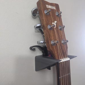 Gitarrväggfäste med tillbehörshållare
